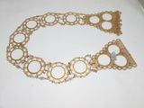 a gold bracelet that has circles and circles on it