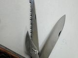 a pocket knife with a knife blade attached to it