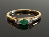 an image of a close up of a ring with a green stone
