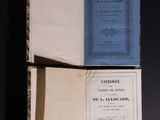 an open book with a blue cover sitting on top of a black table