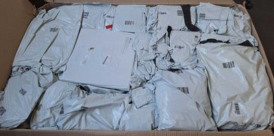 a cardboard box filled with packages and a laptop computer