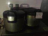 two rice cookers sitting on a counter in a kitchen