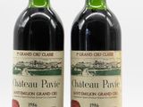 pair of bottles of chateau pavie wine on a white background