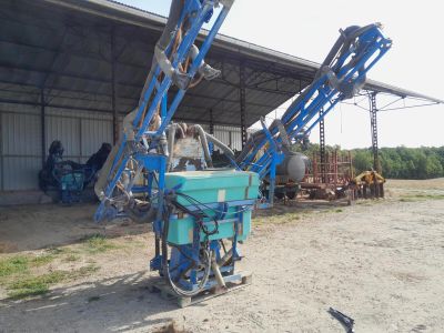 a blue machine that is sitting in the dirt