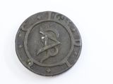 a close up of a coin with a hammer on it