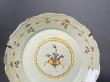 a white plate with a yellow and blue design on it