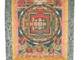 a painting of a buddhist wheel hanging on a wall