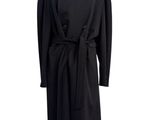 a black coat on a mannequin stand with a white background