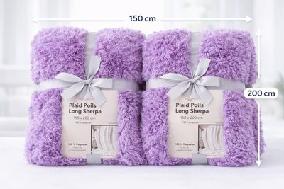 three purple towels are stacked on top of each other on a table