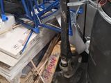a pile of junk on the floor next to a trash can