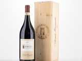 a bottle of wine sitting next to a wooden box