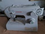 a white sewing machine sitting on a table in a room