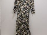 an image of a dress hanging on a hanger in a room
