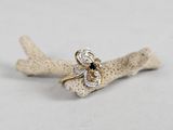 an image of a gold ring with a black and white diamond