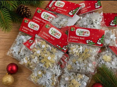 many bags of christmas candy sitting on a table