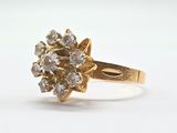 an image of a gold and diamond ring on a white surface