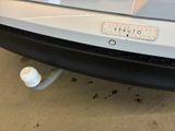 a sticker on the bumper of a car that is parked in a garage