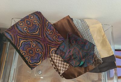 several different types of ties on display in a glass case