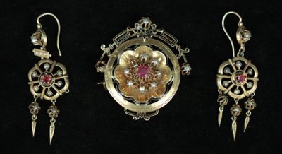 three pieces of jewelry are displayed on a black surface