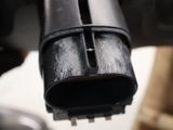 a close up of a black pipe on a white table