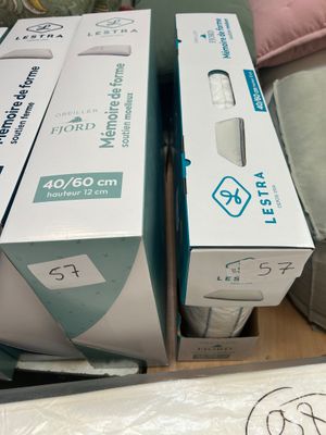 two boxes of wii remotes sitting on top of a table