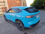 the rear end of a blue suv parked in a parking lot