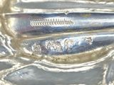 a close up of a silver plate with a spoon and fork