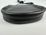 an image of a black purse on a white surface