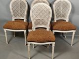 four white painted chairs with brown upholstered cushions