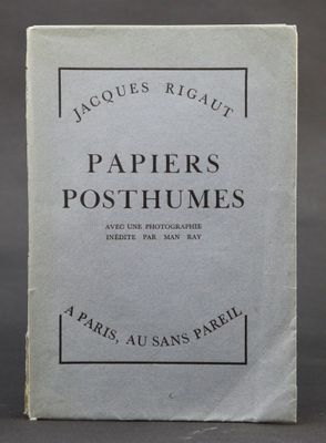 a close up of a book on a table with a black background