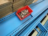 a red box full of shells sitting on a shelf