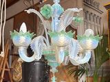 a glass chandelier hanging from a ceiling in a room