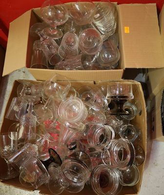 two boxes of empty wine glasses sitting on a table