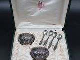 a box with silverware in it on a black surface