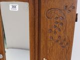 a wooden cabinet with a mirror on top of it
