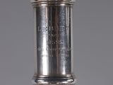 a close up of a silver plated wine bottle with a cork stopper