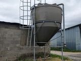 a large metal tank sitting on the side of a building