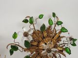 a vase with flowers and leaves in it on a table