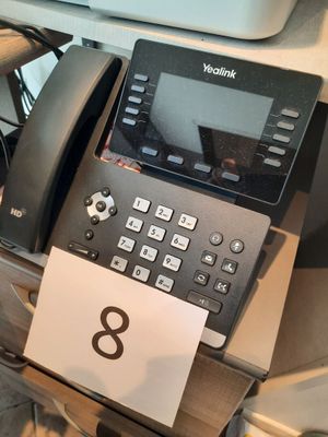 a telephone that is sitting on a desk next to a printer