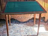 a small table with a green top sitting on the floor