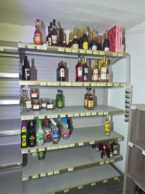 many bottles of alcohol on the shelves in the store