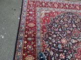 rug on the ground with a person ' s shoes on it