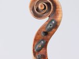a close up of a violin on a stand with a white background