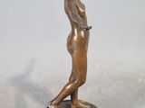 bronze statue of a woman standing on a marble base