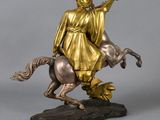 bronze statue of a woman riding a horse with a man on the back