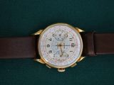 a watch that is sitting on a green surface