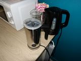 a coffee maker and a cup sitting on a counter
