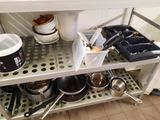 pots and pans on the shelf in the kitchen