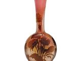 a glass vase that has a picture of a tree on it