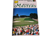 a book with a picture of a crowd of people watching a golf match
